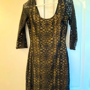 GUESS form fitting black lace dress with a neutral colored tan under the lace
